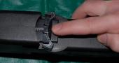 Magazine catch can be pushed back into place with spring